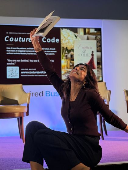 Sonia Aslam holding a copy of Couture & Code above her head