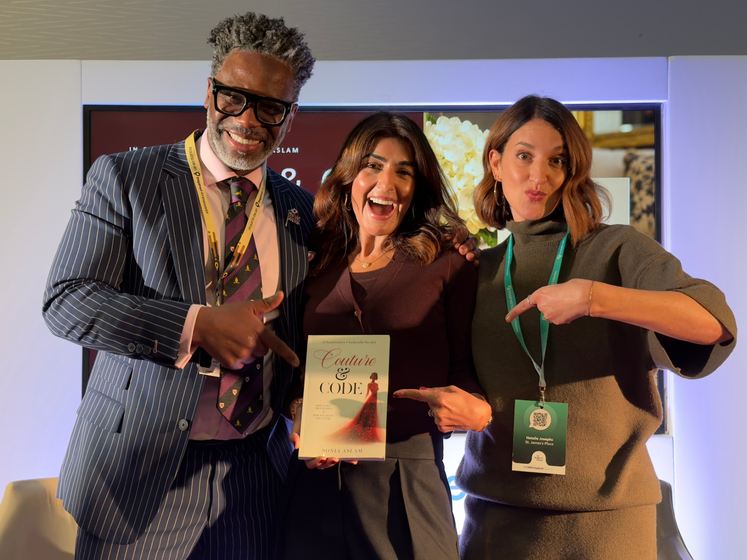 Guests pointing at a copy of Couture & Code alongside Sonia Aslam