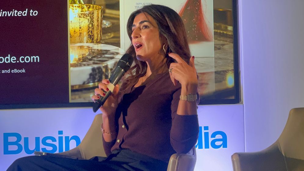 Sonia Aslam making a point on stage, microphone in hand
