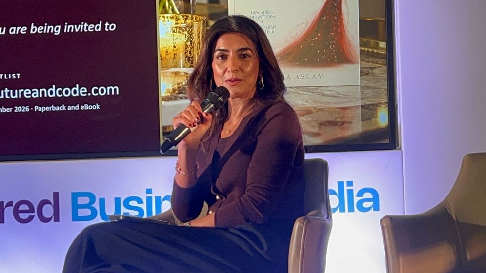 Sonia Aslam speaking into a microphone during the Couture & Code session