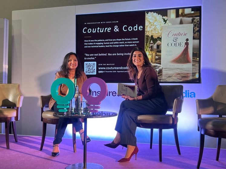 Sonia Aslam and her host on stage, Couture & Code in hand