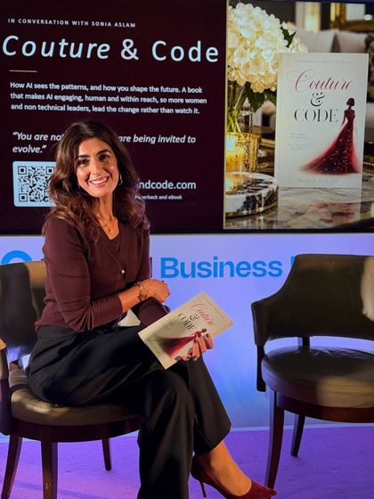 Sonia Aslam seated on stage holding Couture & Code